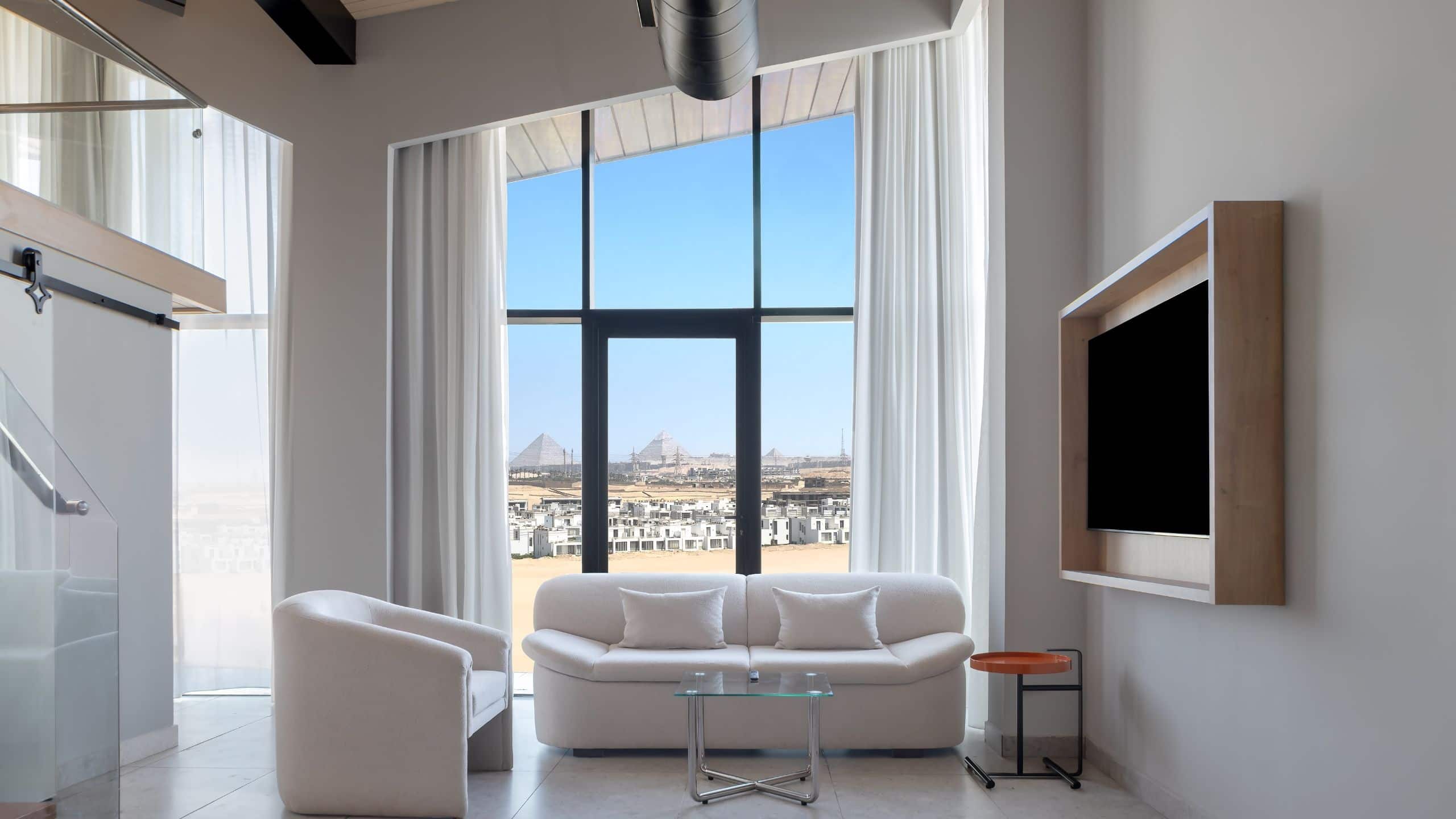 3 of 6 Hyatt Centric Cairo West Premium Loft Suite Pyramids View Seating Area Tv