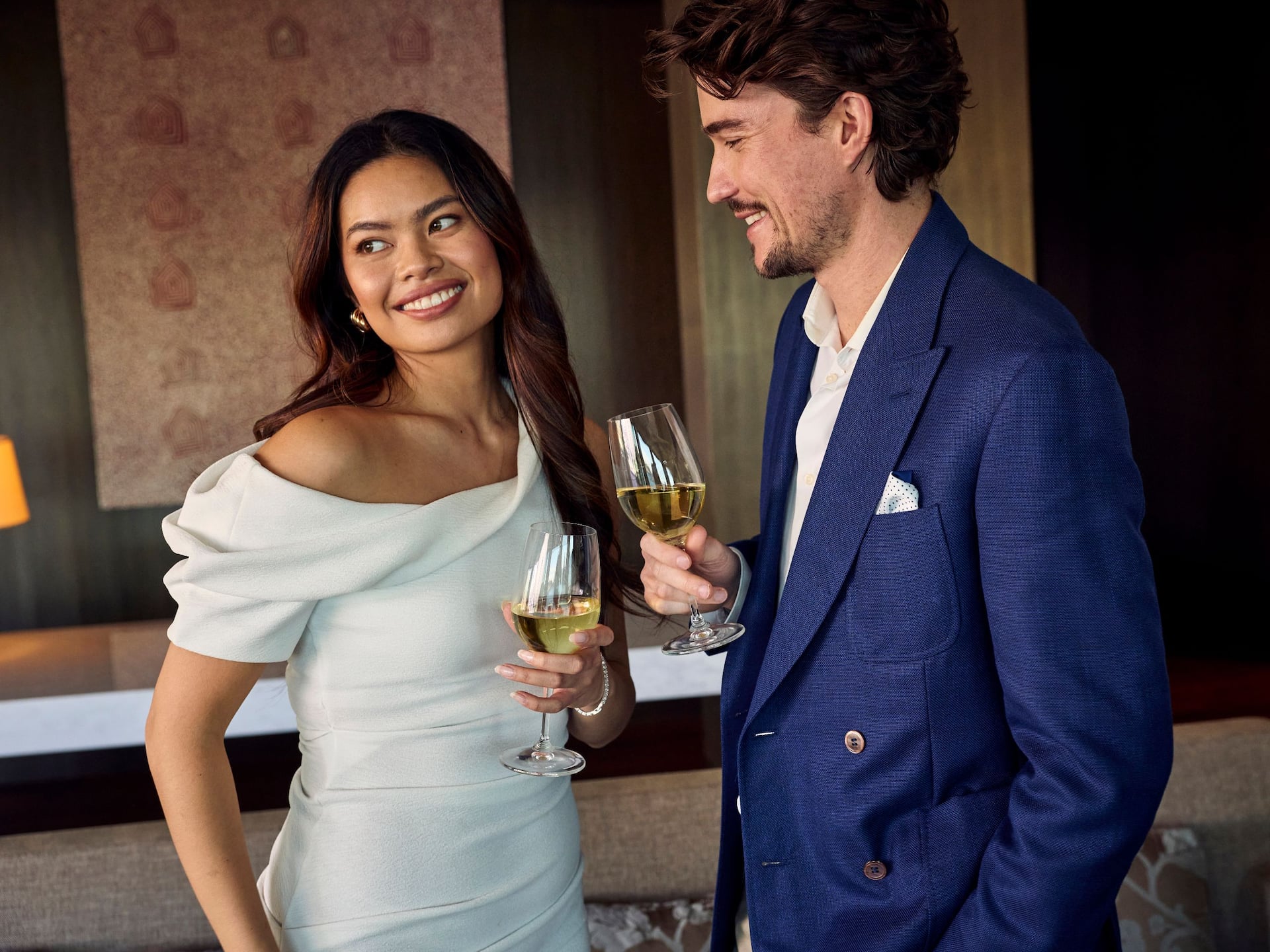 Global Couple Drinks In Room Smiling