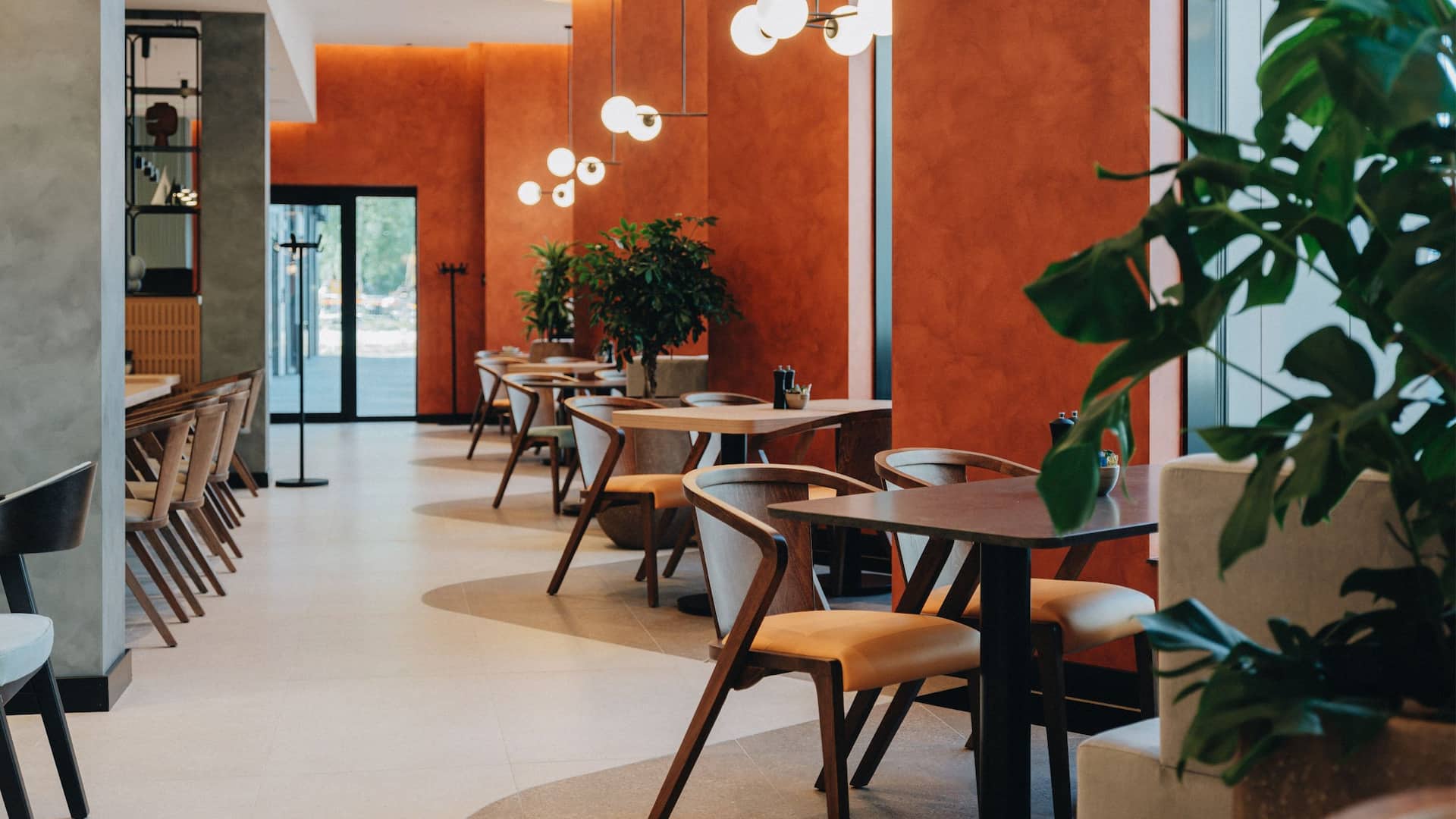 3 of 4 Hyatt Place Tallinn Restaurant With Plants And Window Views