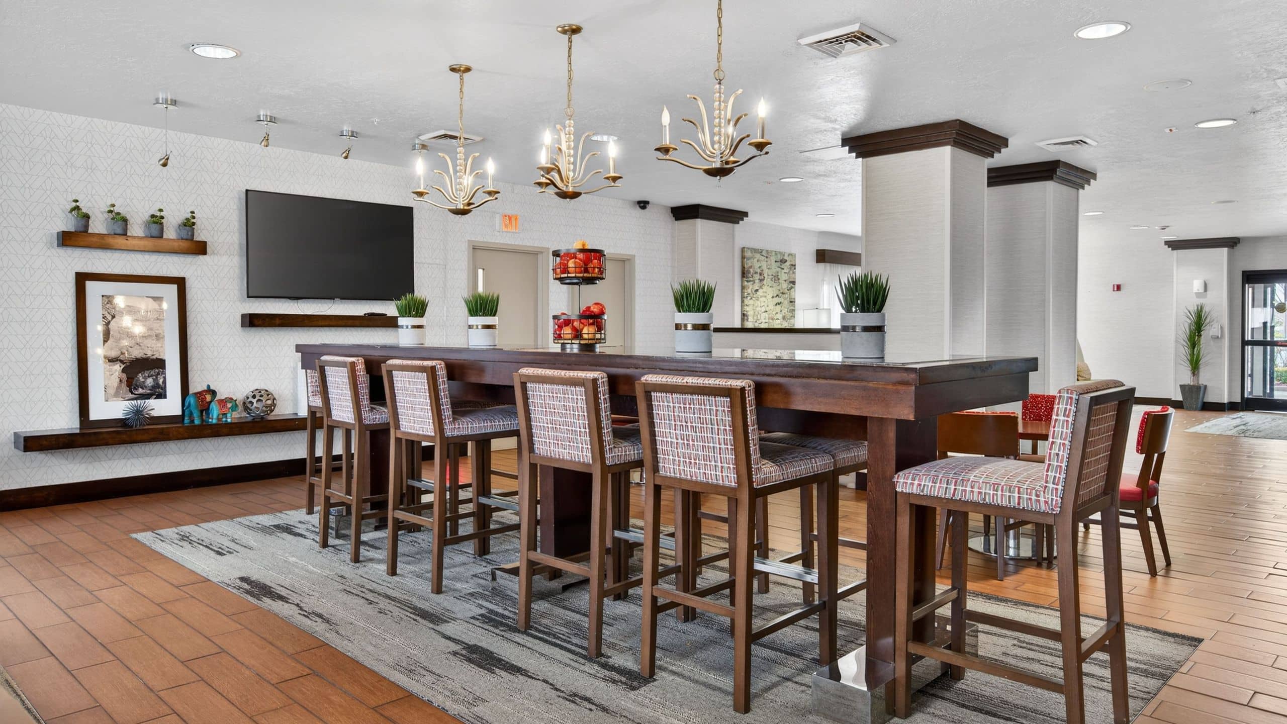Hotel SLC  Communal Table Seating And Television