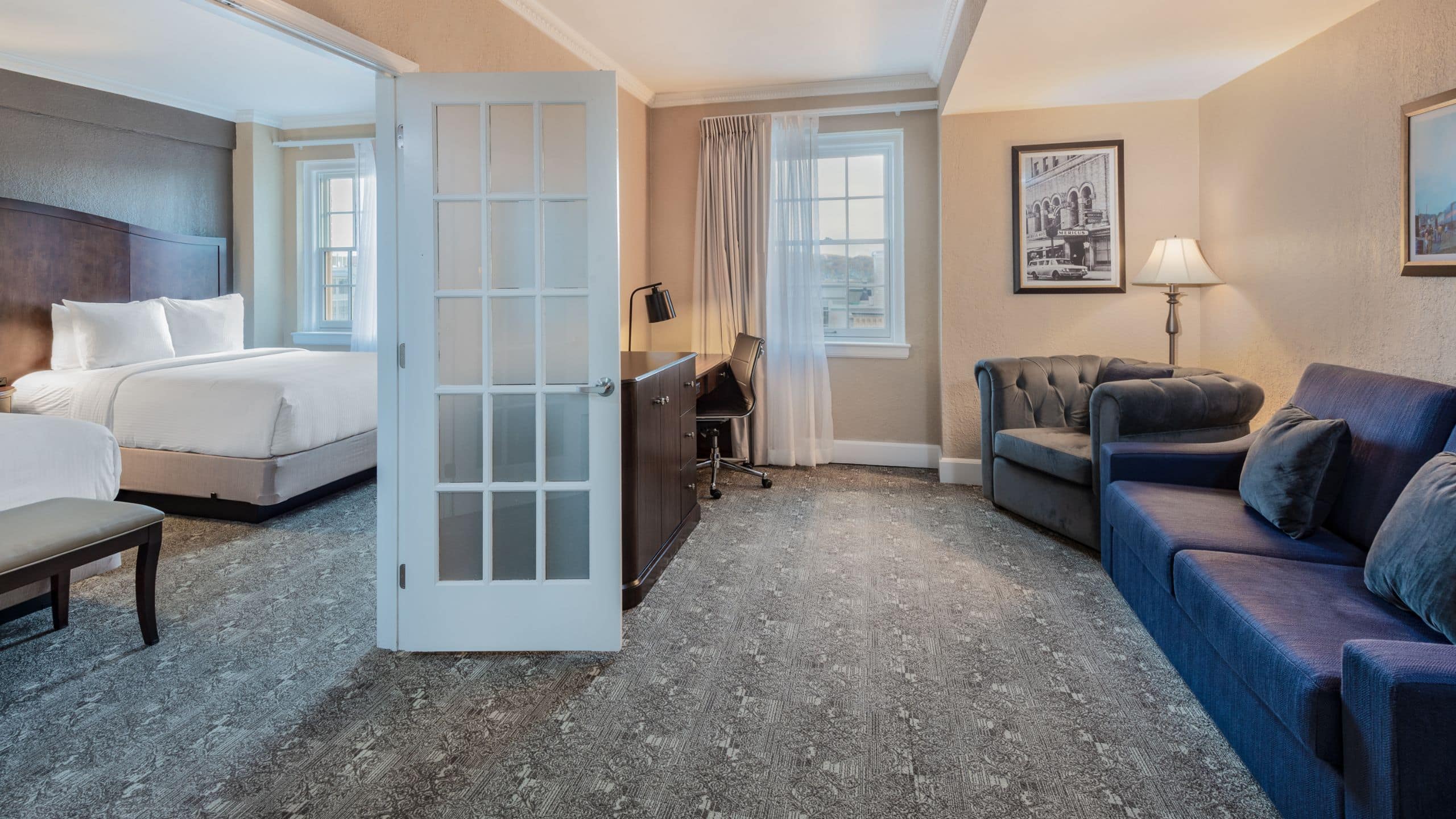 Americus Hotel Queen Suite Bedroom And Living Room Area